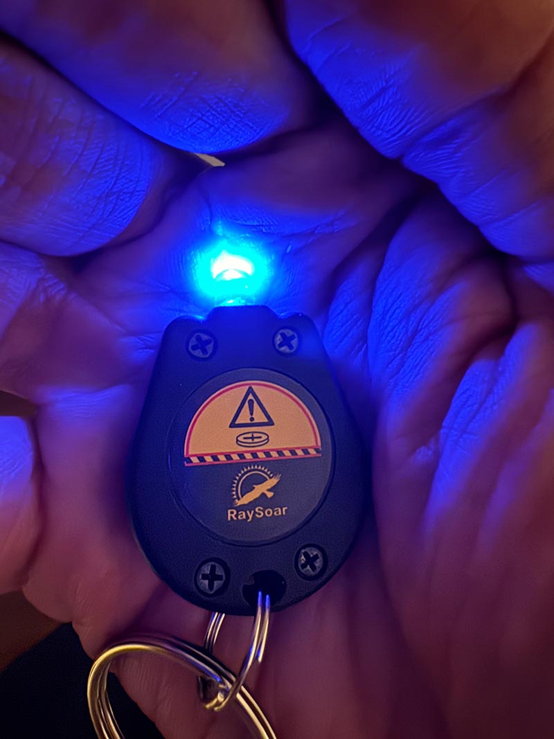 iamge of blue keychain light in the palm of a hand