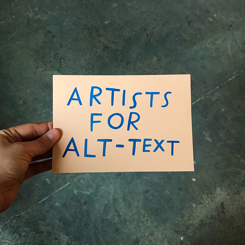 hand holding a card that reads ARTISTS FOR ALT-TEXT in a handmade blue typeface, all with a greenish marble background